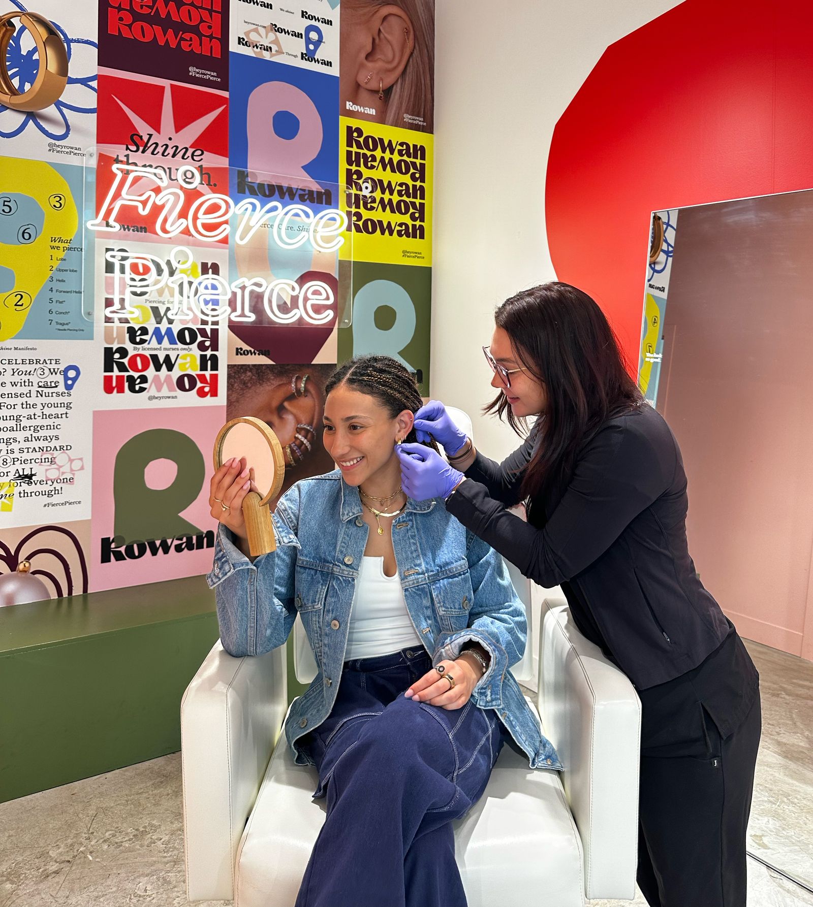 Nurse pierces a client's ears in a Rowan studio.