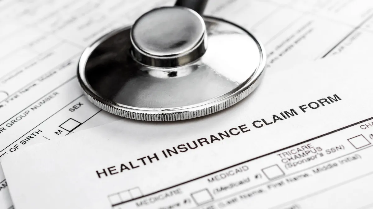 A stethoscope rests on a medical insurance claim form.