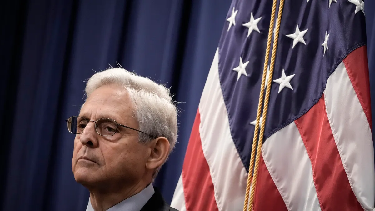 A picture of Merrick Garland standing in front of an American flag