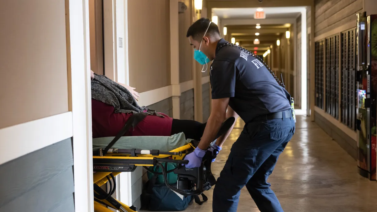 A paramedic wheels transports a patient.